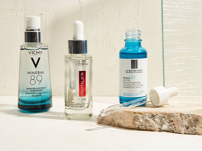Vichy Minéral 89 Hydrating Hyaluronic Acid Serum, La Roche-Posay Hyalu B5 Hyaluronic Acid Serum and L’Oréal Paris Revitalift Derm Intensives 1.5% Hyaluronic Acid Serum serums sitting on a bathroom countertop