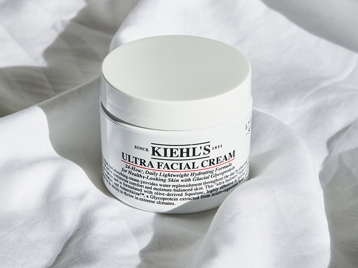photo of the kiehls ultra moisturizer on a white fabric background