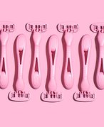 A flatlay of multiple pink razors on a matching pink background 