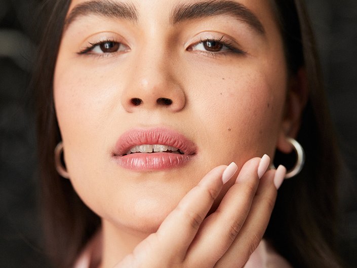 Photo of a model touching the side of her face