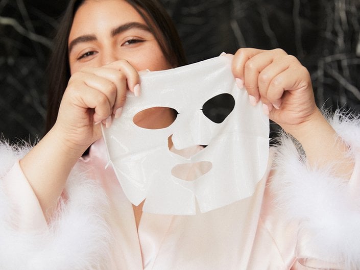 person holding sheet mask