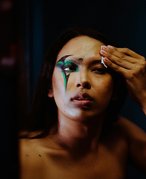 A person wiping their face with a cotton round