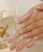 Photo of a person washing their hands 