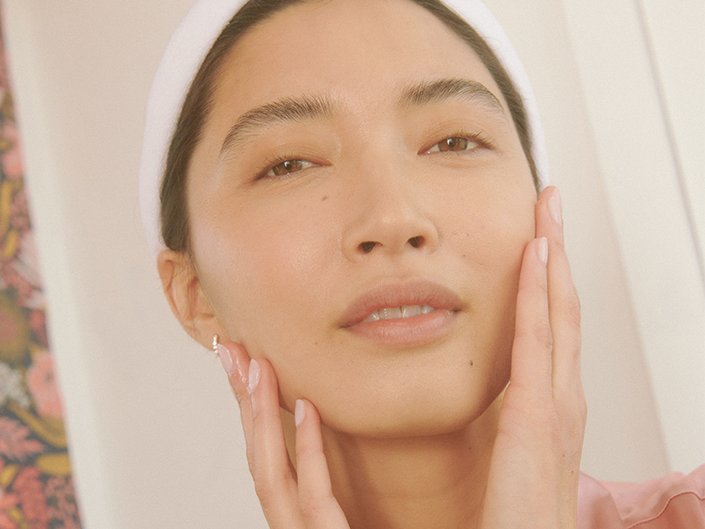 Picture of a person touching either side of their face