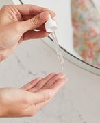 Picture of a model holding a serum dropper