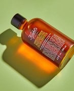 Photo of the Kiehl’s Ferulic Brew Antioxidant Facial Treatment With Lactic Acid on a green background