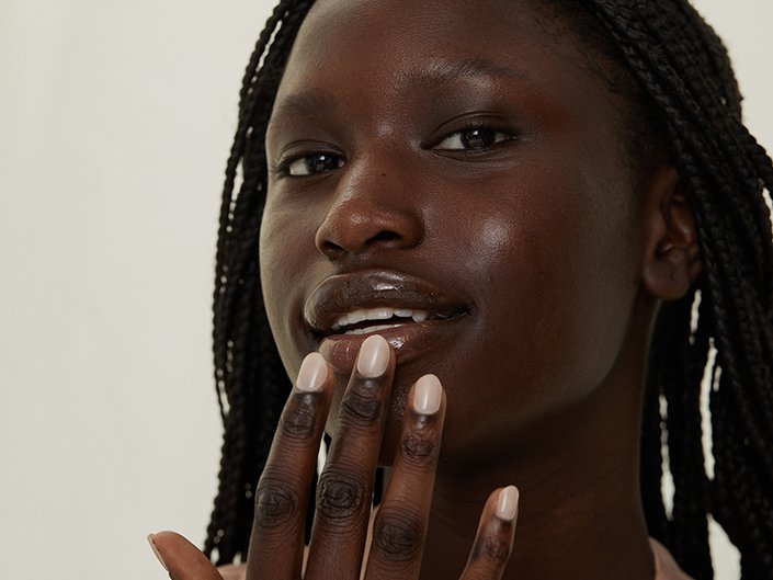 Picture of a model applying product to their bottom lip