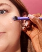 makeup artist applying makeup to a face