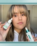 Editor holding up the L’Oréal Paris Bright Reveal 12% Niacinamide Dark Spot Serum and the Kiehl’s Ultra Pure High-Potency 5.0% Niacinamide Serum