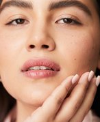 person touching hand to chin