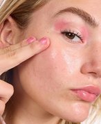 photo of person touching their face