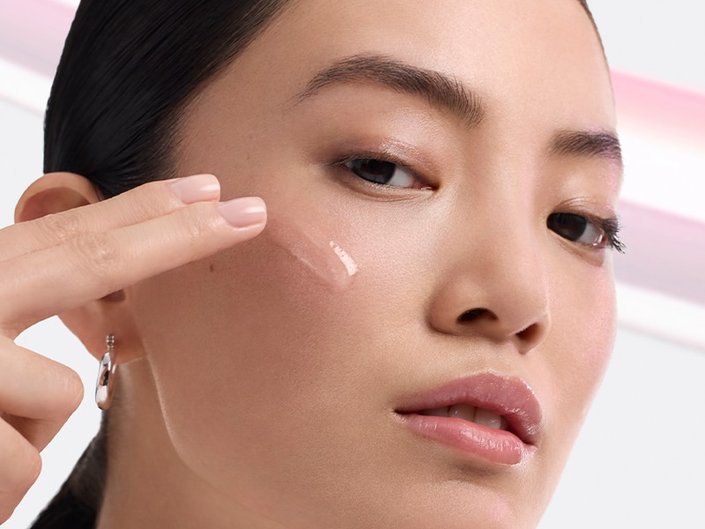 A person applying retinol to face