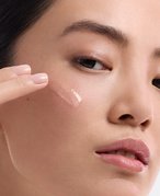 A person applying retinol to face