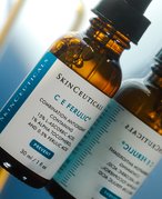 SkinCeuticals CE Ferulic Serum lying on a mirrored surface