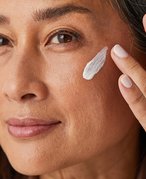 Person with white lotion swatched on their cheek