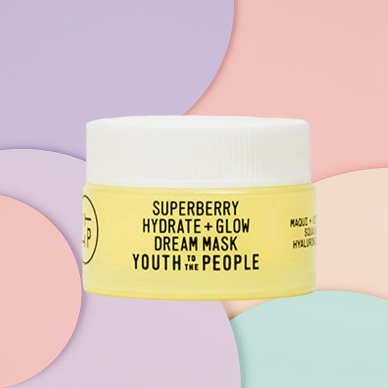 Bottle of Youth to the People Superberry Hydrate + Glow Dream Mask on a textured background